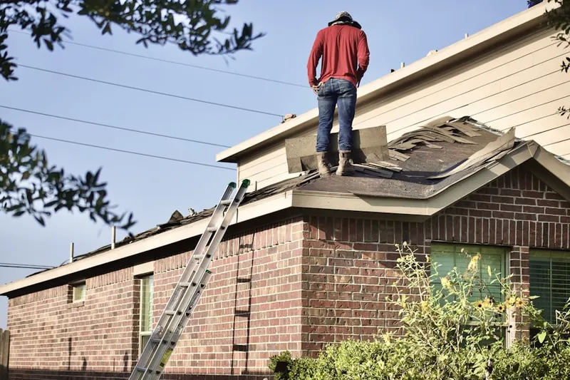 Professional roofer working on a residential roof in Ampere